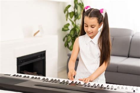 Premium Photo Beautiful Girl Sings While Playing On An Electronic Piano
