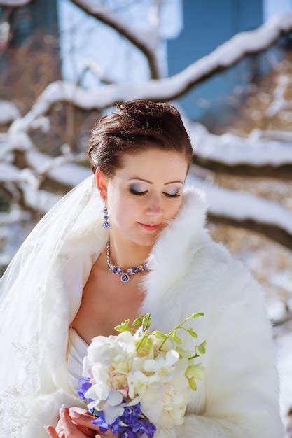 Premium Photo Winter Bride Bride In The Winter Against The Backdrop
