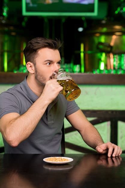 Premium Photo Drinking Fresh Beer Thoughtful Young Man Drinking Beer
