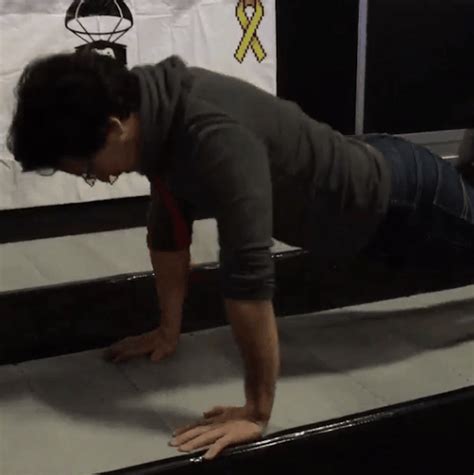 A Man Is Bending Over On The Edge Of A Bed