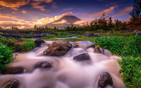 Beautiful Waterfalls From Mountains Pouring On River Surrounded By