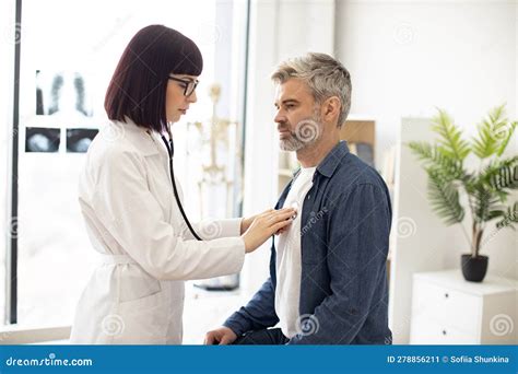 Gp Using Stethoscope During Patient S Checkup In Exam Room Stock Image