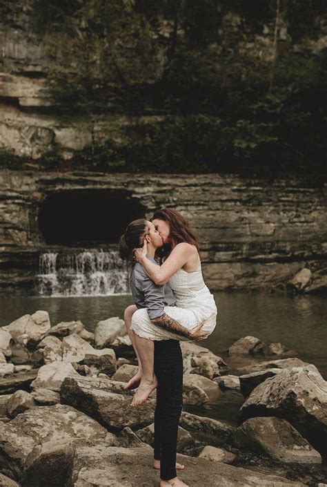 lesbian engagement photo kissing on cliffs and waterfall frolics in this epic enga… lesbian