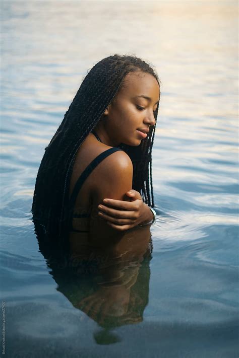 Portrait Of Beautiful Black Woman With Long Hair In The Water Del Colaborador De Stocksy