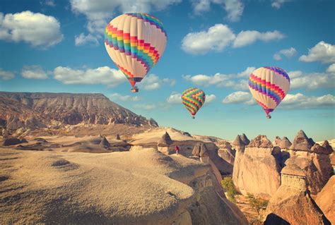 Hot Air Balloon Flying Over Rock Landscape At Cappadocia Turkey Pure