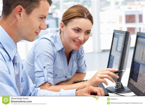 Business Colleagues Helping Each Other On Computer Stock Image - Image ...