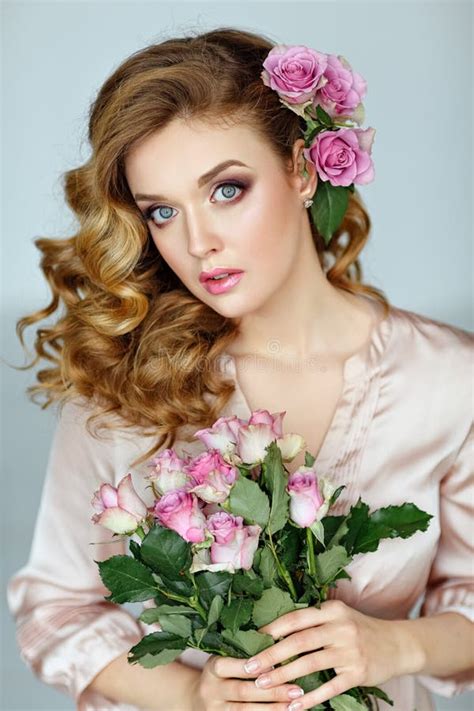 Portrait Of A Beautiful Blonde Girl With Delicate Pink Roses On Stock