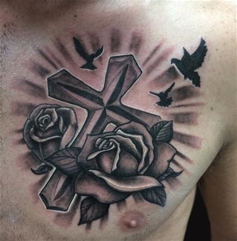 When most people think of adding flowers to their tattoos, a rose is usually top of their list. Rose and Cross Tattoo by Spencer Caligiuri: TattooNOW