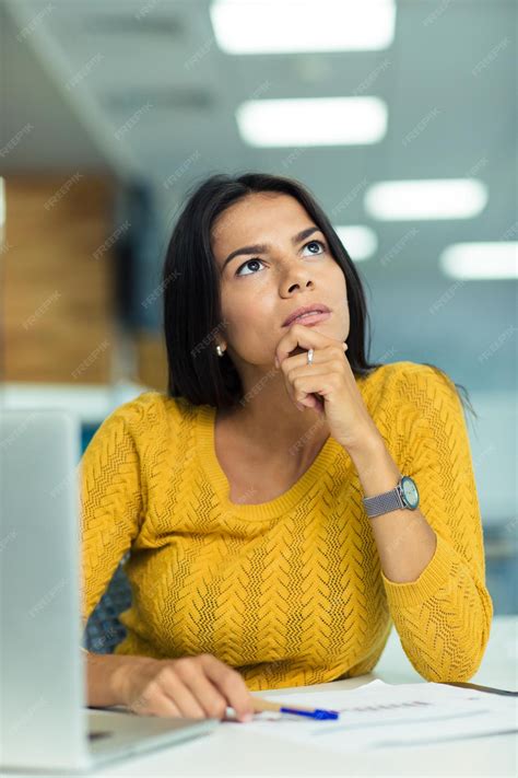 Premium Photo Portrait Of A Thoughtful Businesswoman Sitting At The