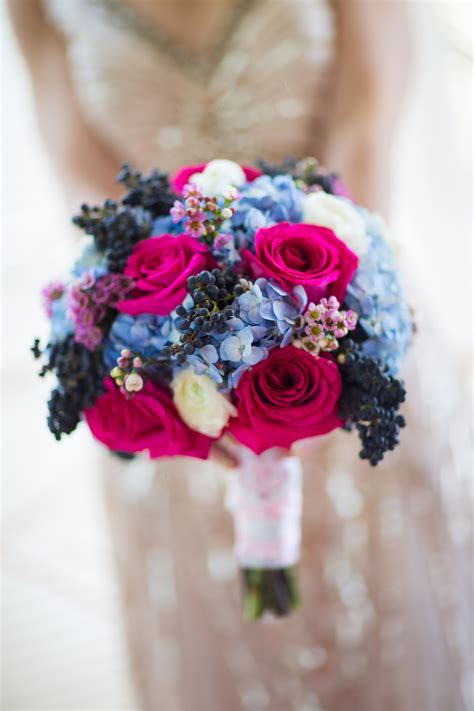 Outdoors, under a beautiful setting sun, featuring what are sure to be stunning florals (these are courtesy of sarah winward, and we are in awe!). Bright Blue and Pink Bridal Bouquet