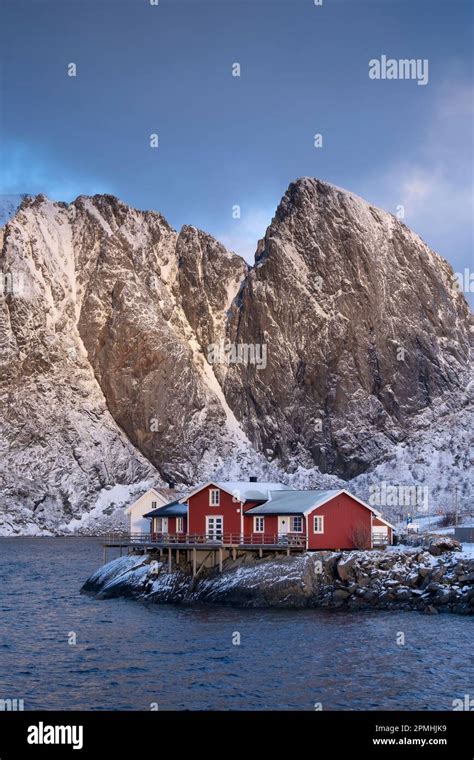 Red Norwegian Rorbuer Cabins And Festhaeltinden Mountain In Winter