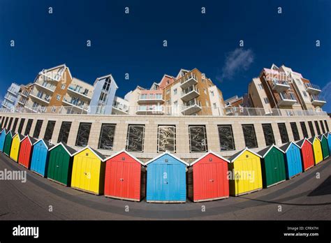 Brightly Coloured Beach Huts And New Build Flats And Apartments Along