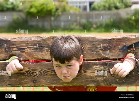Young Boy In Wooden Stocks Uk Stock Photo Alamy