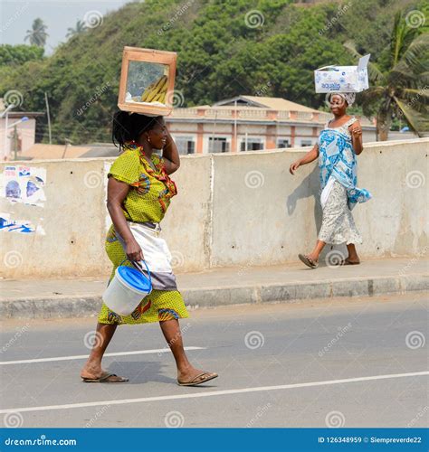 unidentified ghanaian woman carries a box on her head across th editorial stock image image of
