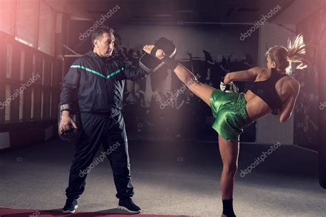 Girl Doing High Kick In Kick Boxing Stock Photo By ©ozimicians 101284516