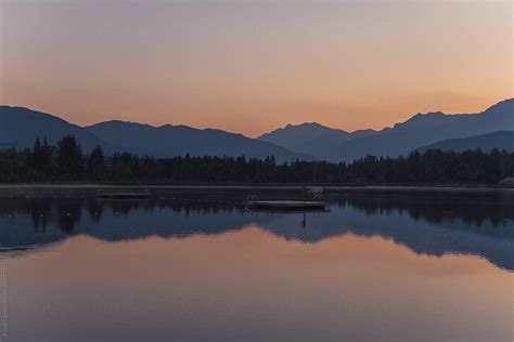 Morning Reflections On A Peaceful Mountain Lake By Stocksy