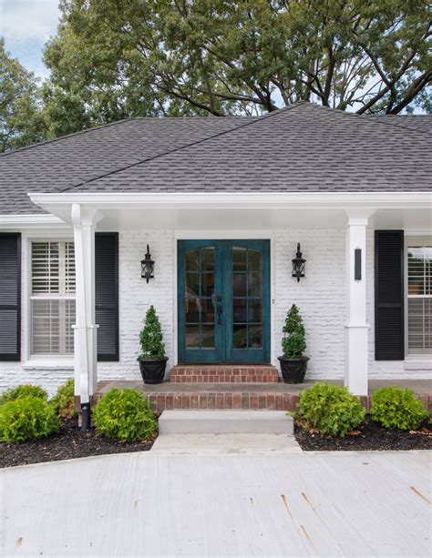 White Brick Exterior With Black Shutters And Double Door Painted