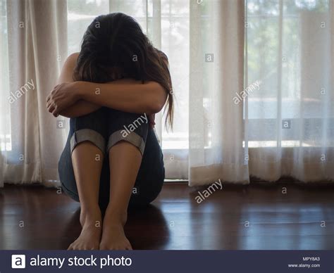 Sad And Despaired Woman Hug Her Knee And Cry While Sitting Alone On The Floor Stock Photo Alamy