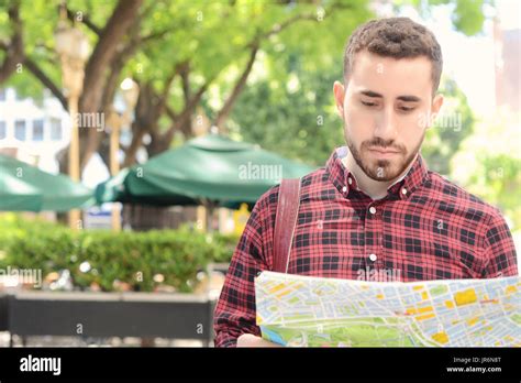 Portrait Of A Young Handsome Tourist Man Looking At A Map Tourism