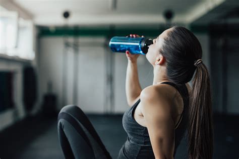Young Fitness Woman Drinking Water In The Gym Stock Photo Download
