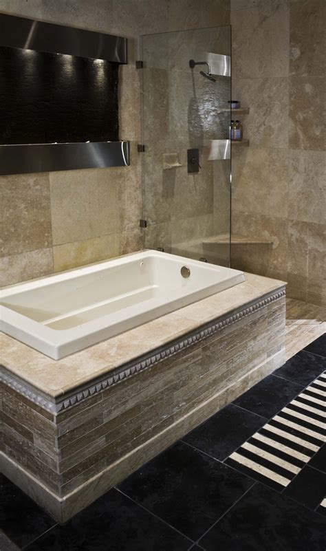 Once you've decided on a tile material, it's time to stretch your creative imagination. Travertine bath paired with charcoal floor tile and a ...