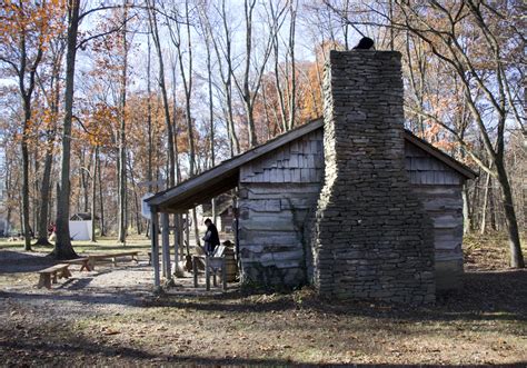 A Stone Chimney With A Log Cabin Handmade Houses With