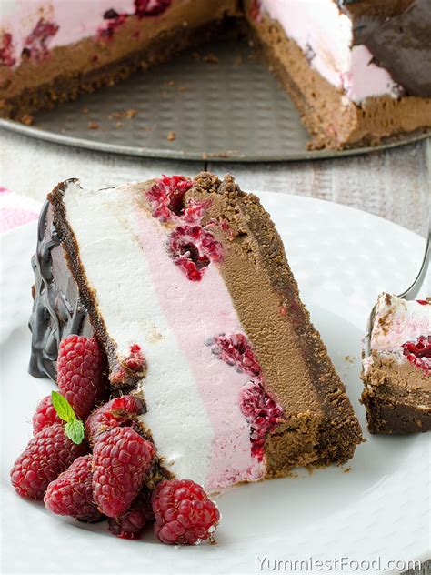 Cheesecake squares, lightened up with yogurt and light cream cheese, baked on a chocolate graham cracker crust drizzled with melted chocolate. No Bake Chocolate Raspberry Cheesecake - Recipe from Yummiest Food Cookbook