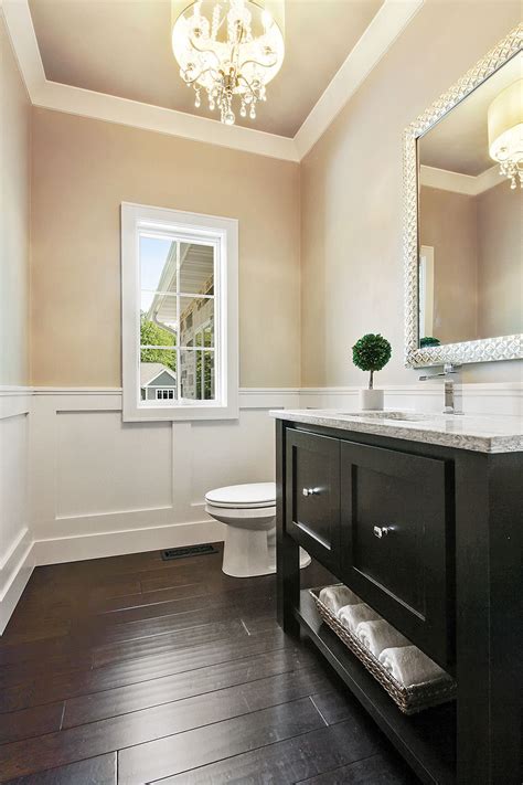 Ivory walls lined with black crown molding beautifully complement this contemporary home office boasting a black leather stool is positioned on a highlight it in black. White painted wood wall paneling and crown molding help ...