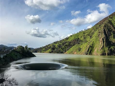 The massive hole in lake berryessa was dry just a week ago but is now sending water gushing into a pipe which ultimately flows out 200 feet away in putah creek. Glory Hole on Berryessa Lake - D i S - Medium