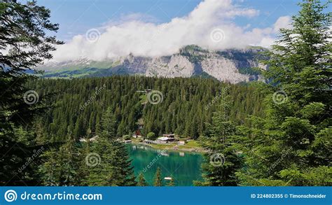 Turquoise Lake Caumasee Surrounded By Forest Reflected In The Water
