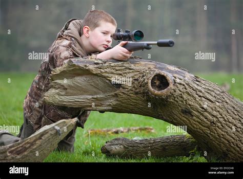 A Young Man With A Rifle Shooting Pests During The Day In The