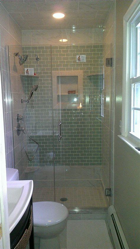 Dark wood of the floor cabinet and separate (one for each of the two sinks) medicine cabinets corresponds harmoniously with dark brown taps and mosaic accents on a tile backsplash wall. Shower with Glass tile accent wall | home ideas | Pinterest
