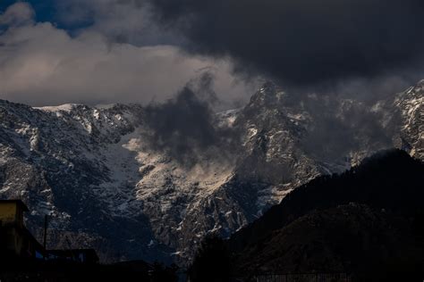 Snowy Mountain Peaks Under Cloudy Sky · Free Stock Photo