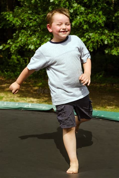 Child Playing While Jumping On Trampoline Outdoors Stock Image Image