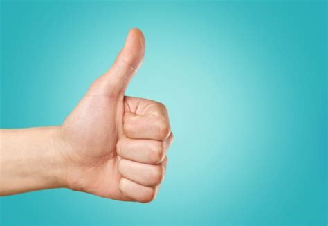 Premium Photo Closeup Of Male Hand Showing Thumbs Up Sign Against