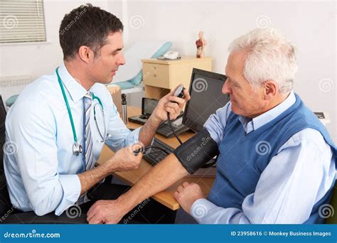 British Doctor Taking Senior Man S Blood Pressure Stock Photo Image
