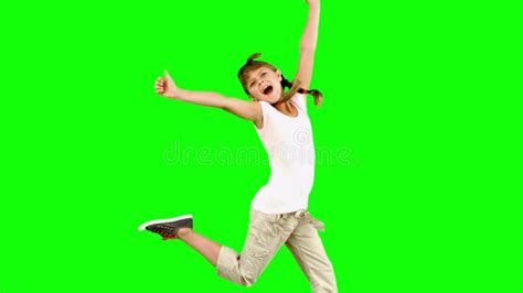 Little Boy Jumping Up And Catching Rugby Ball On Green Screen Stock