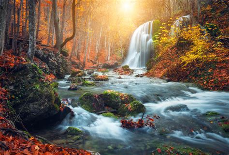 Waterfall At Mountain River In Autumn Forest At Sunset