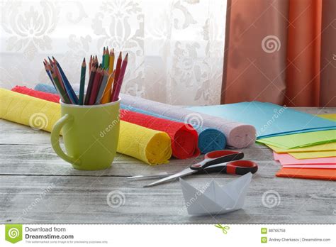 Set Of Origami Boats And Square Sheets Of Colored Paper On ...