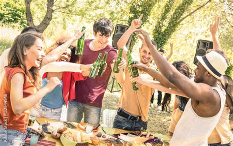 Young Multiracial Friends Toasting Beer At Barbecue Garden Party