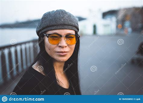 Beautiful Woman In Yellow Sunglasses On Embankment Portrait Of Brunette Woman In Cap Looking At