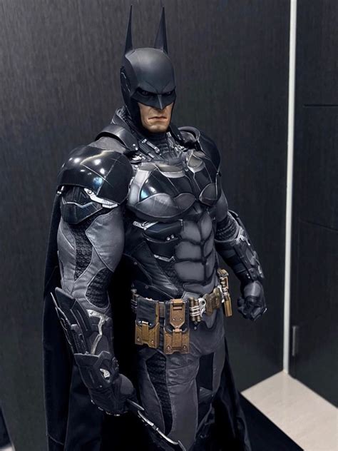 A Man Dressed As Batman Standing In Front Of A Mirror