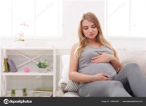 Pegnant Woman Caressing Her Belly At Home Stock Photo Milkos 159602644