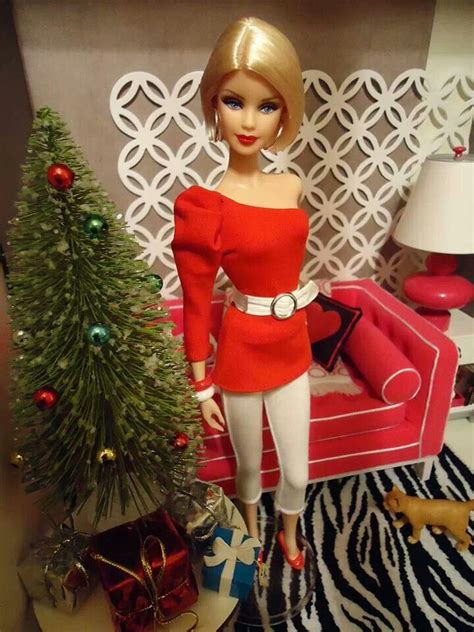 A Barbie Doll Standing Next To A Christmas Tree