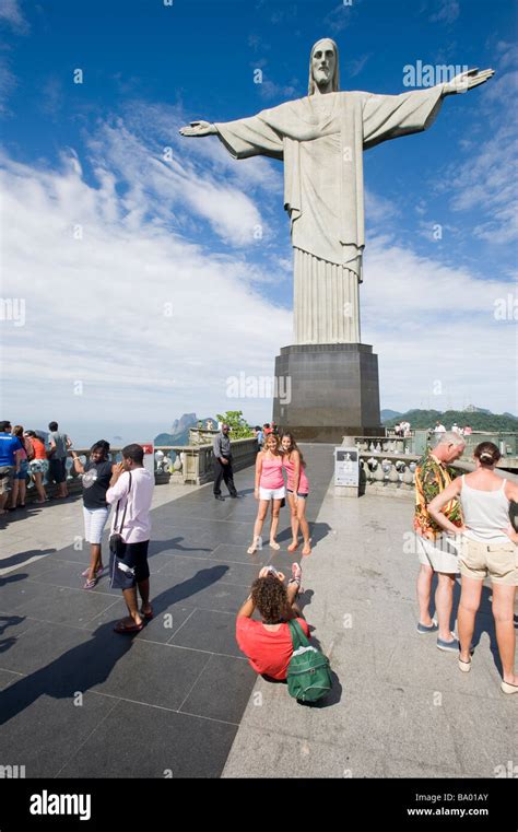 Rio De Janeiro Brazil Tourists Take Pictures On Corcovado Hill Below