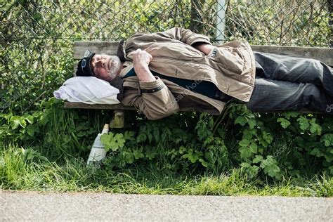 Homeless Man Sleeping On Bench — Stock Photo © Ysbrand 111116174