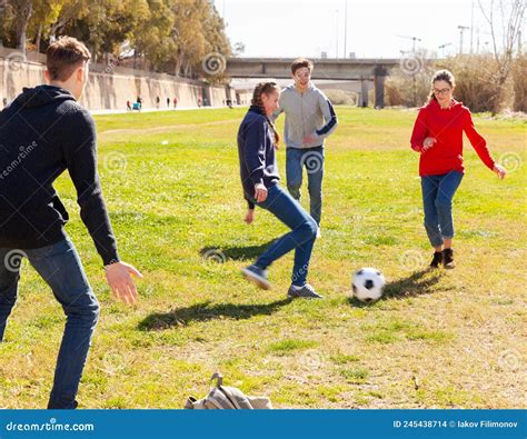 Company Of Teenagers Playing Football In Park Stock Photo Image Of