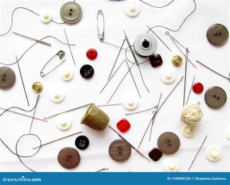 A Set Of Needles Thimbles Buttons Pins Threads Of Black And Red