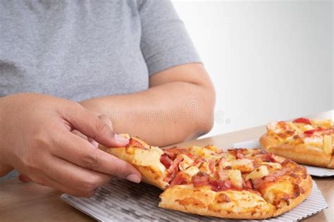 hungry overweight woman holding pizza and happy to eat pizza concept of binge eating disorder