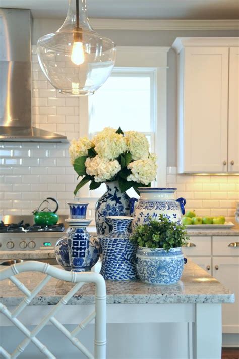 White Kitchen With Flowers On A Decorated Island Hgtv